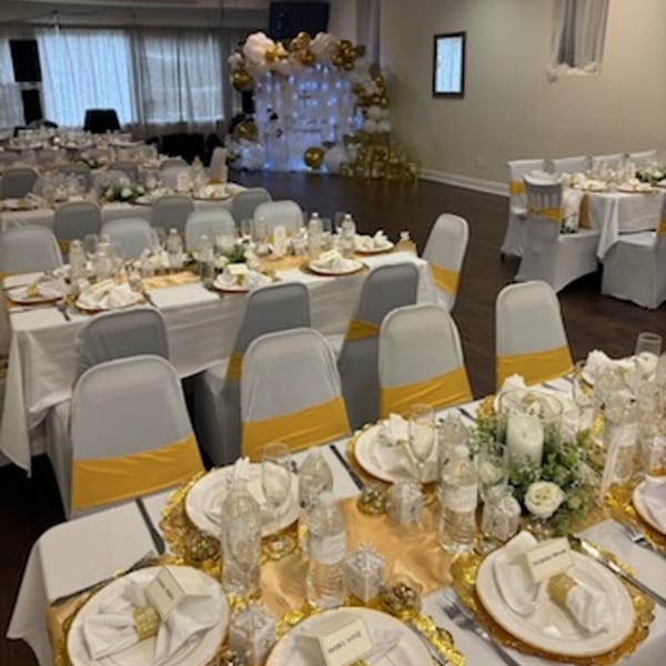 Elegant Tequila's 55 dining room set for an event with white and gold decor.